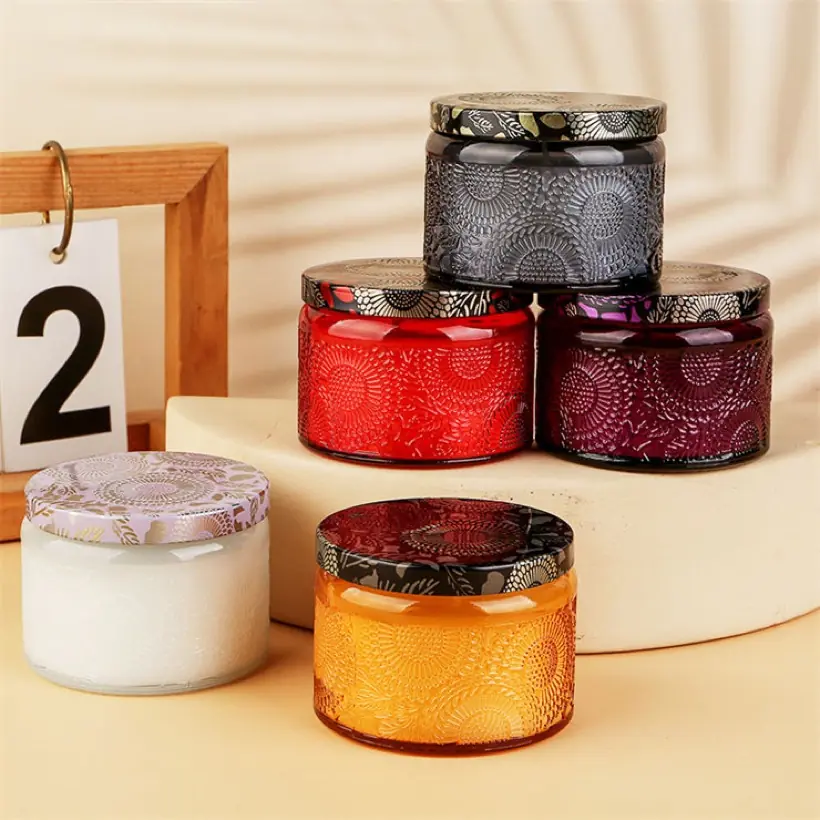 Colored embossed glass candle jars with patterned lids